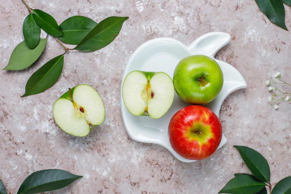 Fresh apples with green leaves representing a simple and natural daily diet