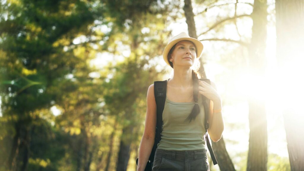 Woman walking outdoors in sunlight to support healthy vitamin D levels