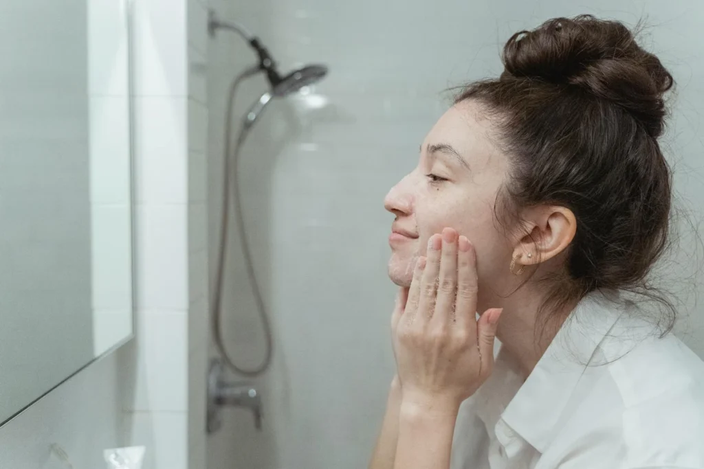 woman applying rice water on face as part of daily rice water for skin routine