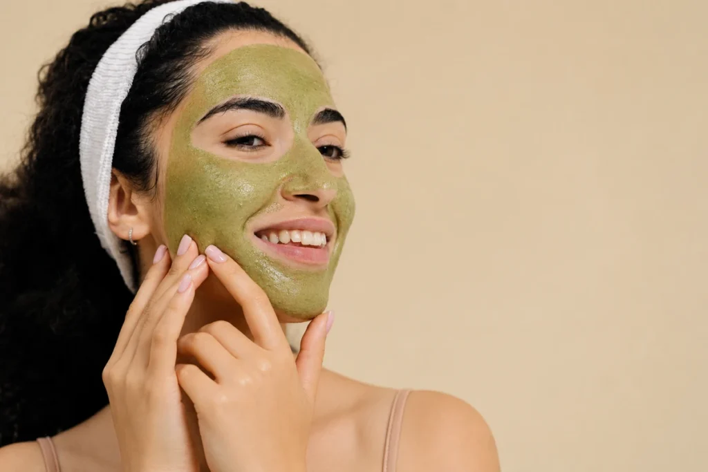 Woman applying a natural neem face pack to demonstrate neem benefits for skin, including support for oily skin, acne-prone skin, and a healthy-looking complexion.