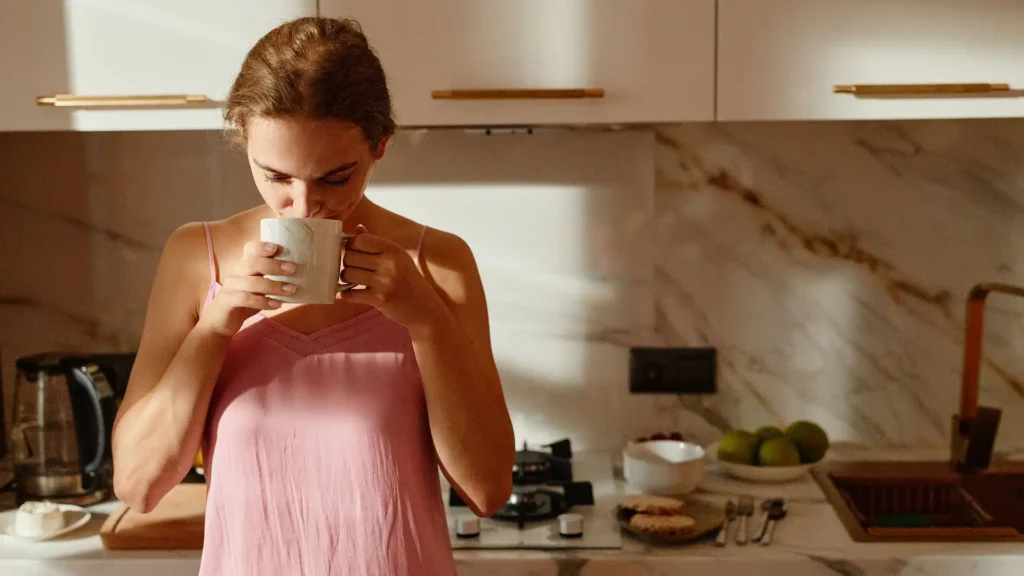 Woman enjoying a morning drink as part of a healthy routine for liver health